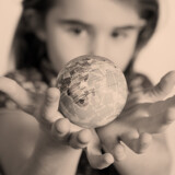 Cute little girl holding World Globe on her Hands